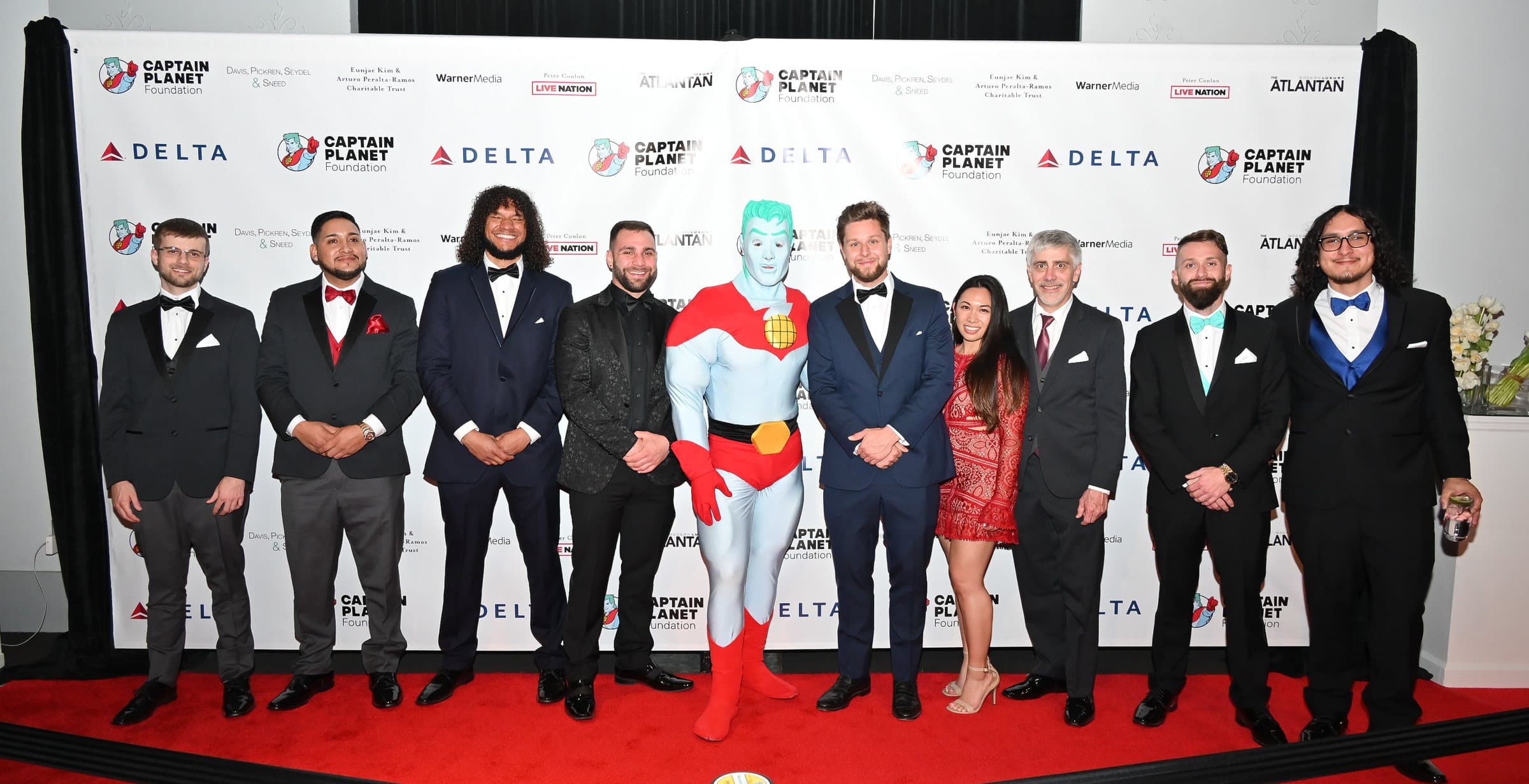 The Earthcore Group crew in black tie with Captain Planet at the Captain Planet Foundation gala in Atlanta